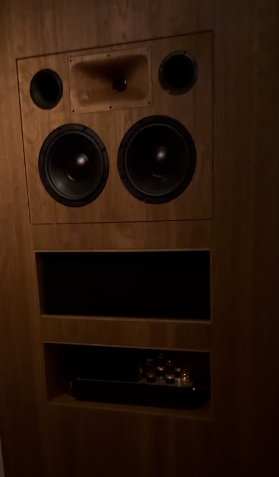 CUE’s speaker installation and equipment shelving within the wood-panelled wall.